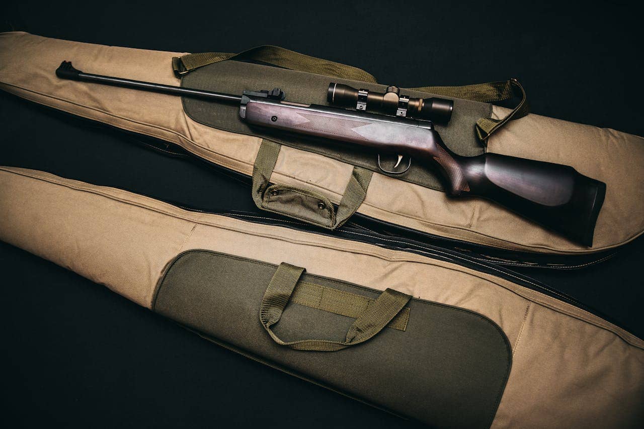 Black Rifle With Scope and Brown Gig Bag